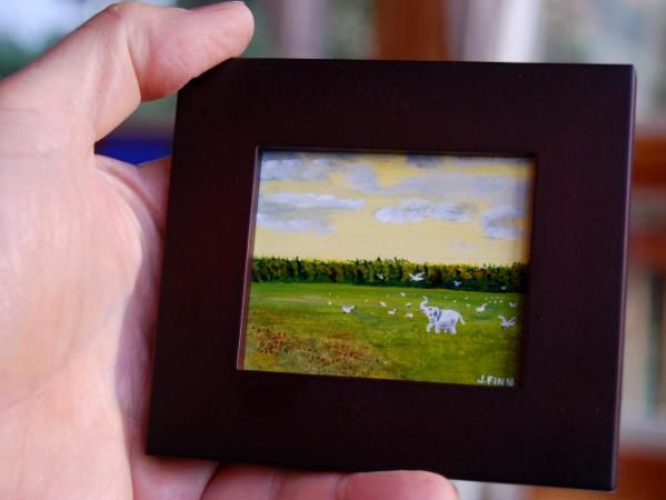 White Elephant Playing in a Field With Snow Geese